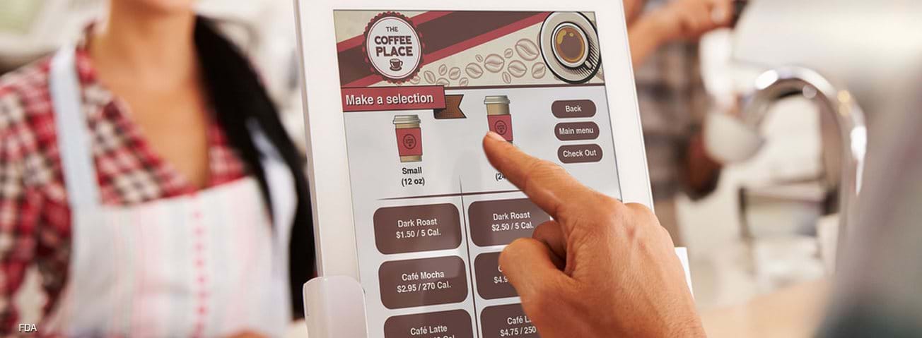 Customer using an electronic menu showing calorie information 