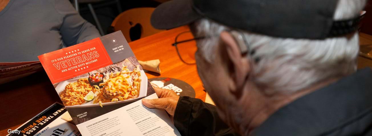 Veteran looking over a menu at a restaurant