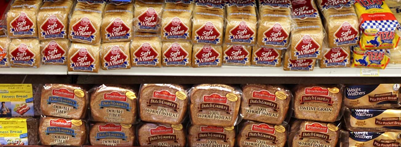 Wheat bread packages on shelves in grocery store