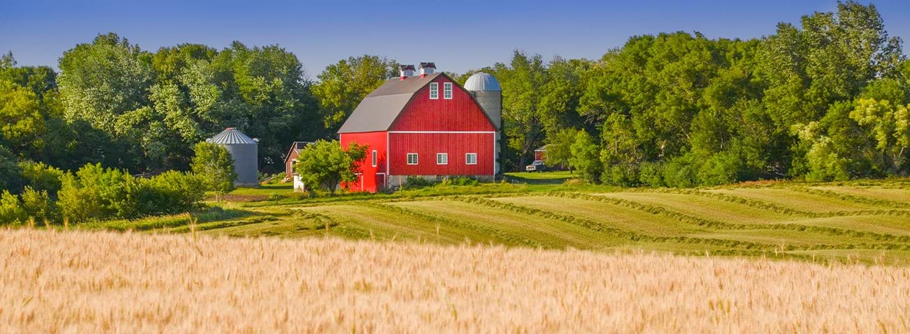 Red barn in farm field