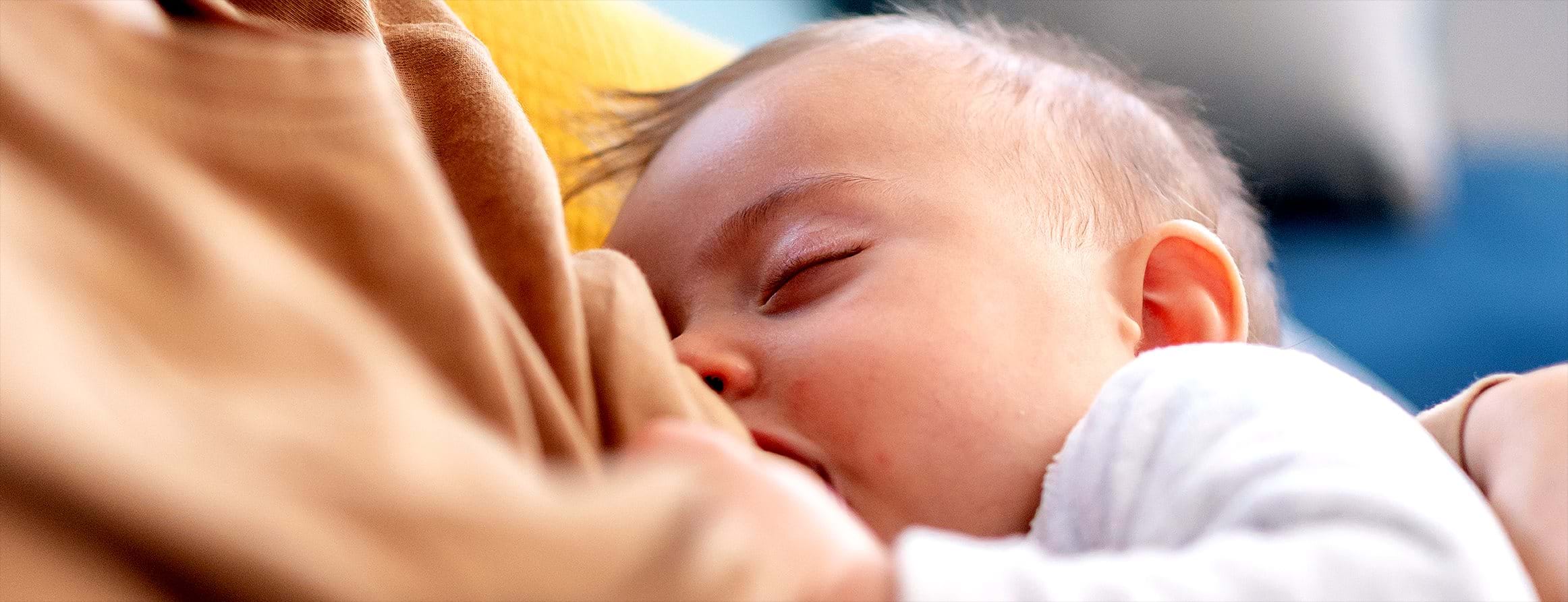 Photo of infant breastfeeding.
