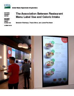 Photo of two young women looking at a menu board in a restaurant