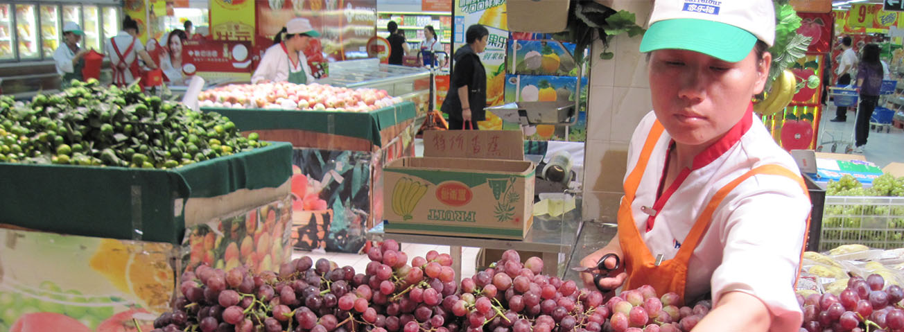 Chinese food inspector looking at grapes