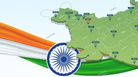Map of India with the colors of the Indian flag (orange, white, and green) flowing through the background.