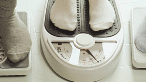 A photo of stockinged feet on scales