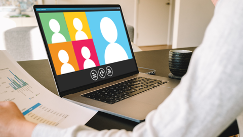 Woman at desk with laptop open to a graphically designed group call