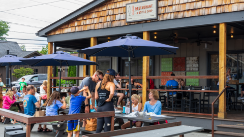 A photo of people dining on a restaurant patio